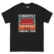 A design with a vintage red sofa centered on a background of horizontal stripes in teal, light yellow, and orange. The white text "CURRENTLY" is at the top, and "IN MY COMFORT ZONE" is at the bottom, separated by an orange stripe with black stars.