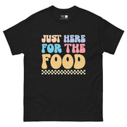 The phrase "JUST HERE FOR THE FOOD" in a playful, bubbly font. "JUST" is light peach, "HERE" is light blue, "FOR" is light blue, "THE" is pink, and "FOOD" is light orange. A checkered pattern in yellow and white is at the bottom.